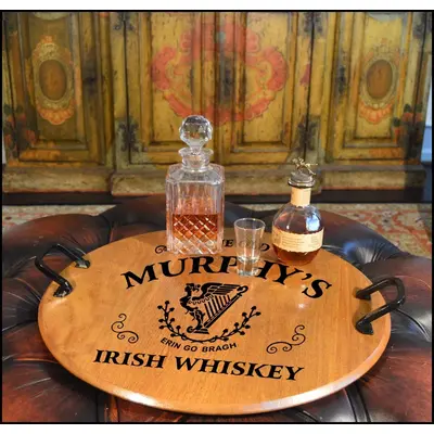 21-inch round authentic oak barrel head serving tray with wrought iron handles displaying Irish whiskey decanter and glass in a rustic bar setting.