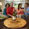 Couples enjoying wine around a personalized barrel head lazy susan centerpiece on a coffee table.