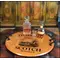21-inch authentic oak barrel head serving tray with wrought iron handles displaying whiskey decanter and glasses in a rustic bar setting.