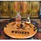 Authentic 21-inch round oak barrel head serving tray with wrought iron handles displaying whiskey decanter and glass in a rustic bar setting. 'Drunken Sailor' Barrel Head Serving Tray