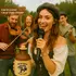 Woman singing into a microphone while holding an Irish Gold “Feelin’ Lucky” moonshine jug, with musicians celebrating behind her, emphasizing craftsmanship and festive Irish barware.