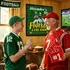 Grandfather and grandson enjoying a personalized football dartboard cabinet in a family game room.