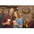 Brew pub quarter barrel wall sign displayed in bar setting with friends enjoying beer.