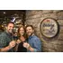 Friends enjoying Scotch whisky in home bar with Gilchrist barrel end wall decor displayed behind them
