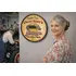 Personalized garage barrel head wall sign displayed in auto repair shop with mechanic holding wrenches beside classic car.