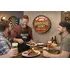 Friends enjoying beer and barbecue in front of personalized quarter barrel BBQ sign