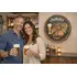 Personalized Charlie’s Brew Pub barrel head sign displayed above home bar with couple holding beer glasses.