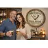 Personalized Michael’s Pool Room barrel head wall sign mounted above home bar with couple holding beer glasses.