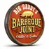 Handmade barrel end BBQ sign mounted on brick wall showing raised 3D pig detail