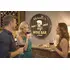 Barrel head wine bar sign displayed in home wine bar setting with guests enjoying wine