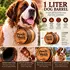 Pooch Hooch 1-liter American white oak dog barrel on a Saint Bernard, showing medium-charred interior, genuine leather strap, engraving and barrel dimensions.