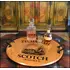 21-inch authentic oak barrel head serving tray with wrought iron handles displaying whiskey decanter and glasses in a rustic bar setting.